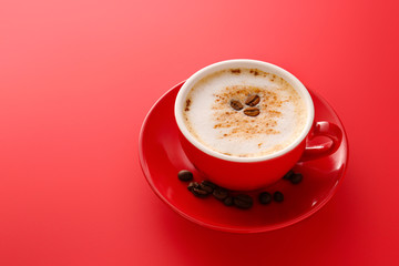 Cup of tasty cappuccino on color background