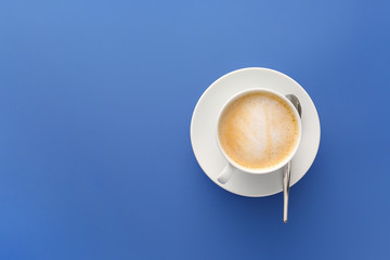 Cup of tasty cappuccino on color background