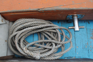 Circle of old rope on the boat. Curly, macro.