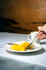 Mango sticky rice thai dessert on setting table background.