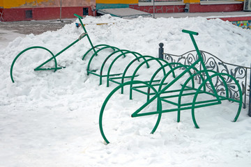 Snow-covered bicycle parking near the shopping center