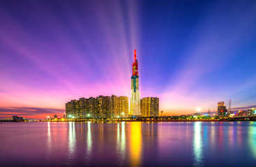 Naklejka premium Skyscraper at sunset with impressive apartment, showing urban development with modern architecture to bring international in Ho Chi Minh City, Vietnam
