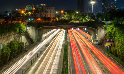 Fototapeta na wymiar Traffic rushes at Thu Thiem tunnel exit at night. This is an economic transport project across the Saigon river in Ho Chi Minh City, Vietnam