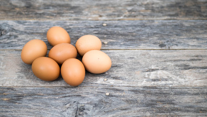 Eggs on the old wooden plank background