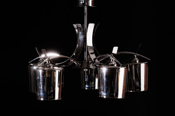 Modern lamp, chandelier on a black background. Lighting element of the interior. environmental materials of lamps