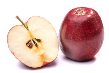 half of a ripe red Apple next to a whole close-up on a white isolated background