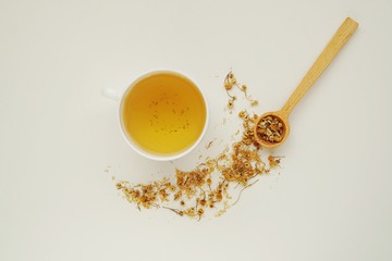 Healthy organic dried camomile tea on white background.