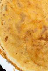 Fried pancakes. The texture of the dough. A treat on Shrove Tuesday. Culinary product.