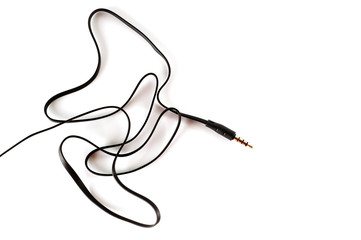3.5 mm plug with a black wire, shot large on a white background. Background for music and computer equipment