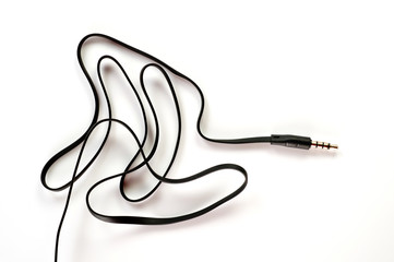 3.5 mm plug with a black wire, shot large on a white background. Background for music and computer equipment
