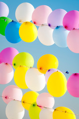 Colorful balloons tied on strings, waiting to be popped by shooters in a game on the shore of the Sea of Marmara in Istanbul, Turkey