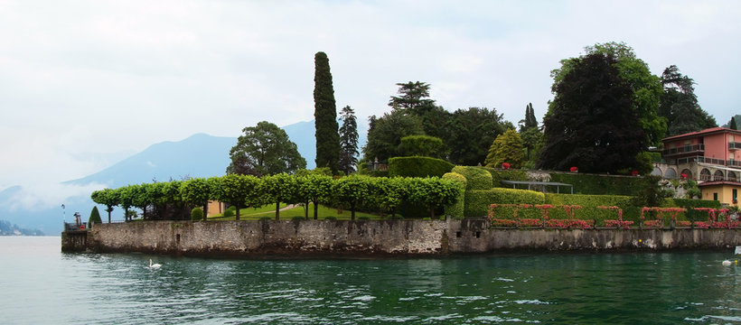Panoramic view of Como lake with villages and mountains shrouded in clouds. Torno. Italy.