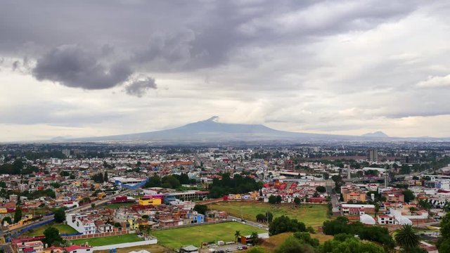 Malinche inactive volcano of Puebla seen from Pyramid of Cholula at cloudy day with dramatic sky, time lapse.