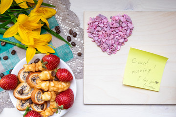 strawberry, cookie hearts with a Cup of black coffee beans, with yellow flowers and a note Good morning happy Valentine's day