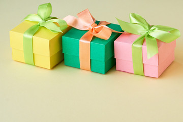 Multicolored gift boxes with ribbon on a light background