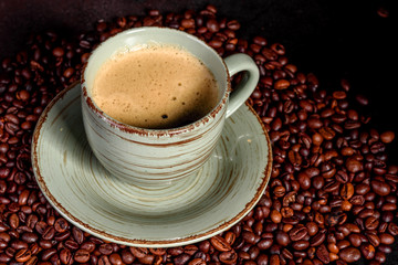 Preparation of aromatic morning coffee. Empty white coffee cup on a dark table