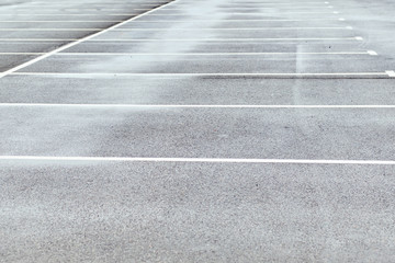 Empty parking on asphalt with markings.