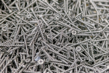 Black screws, background, texture in the store.