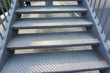 Steel stair step to walk up or walk down to the outdoor public bridge