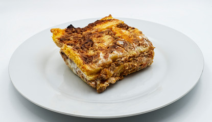 Slice of traditional italian Lasagne on a white plate. © Claudio Caridi