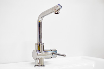 Modern metal faucet for water supply.