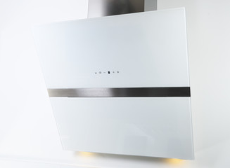 Close-up of a touch control panel on a white glass kitchen hood.White inclined cooker hood. Simple light modern kitchen design