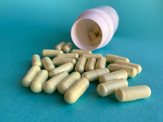 Some pills in a blue background, antibiotics and probiotics