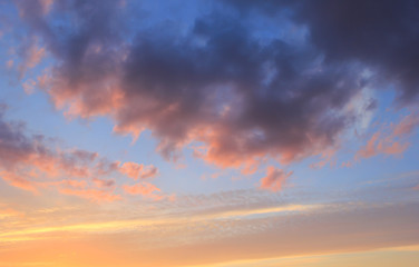 Naklejka na ściany i meble Spring blue sky at sunset with gray clouds.