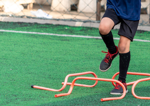 Boy leg unrecognized kdi is training with equipment on soccer football training ground