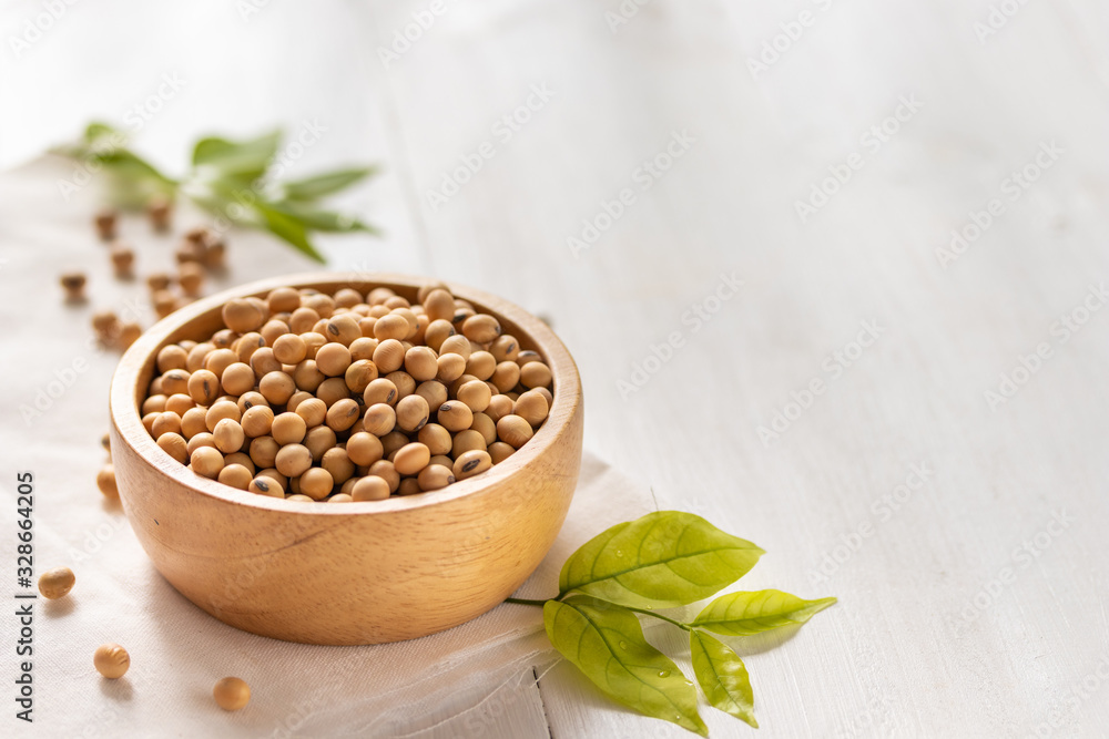 Wall mural soybean or soya bean in a bowl on white wooden background