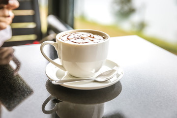 Hot art Mocha Coffee in a cup on black table.