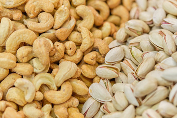 Background and texture of cashews and pistachios.