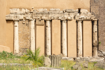 ancient roman columns embedded in a cement wall