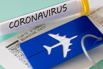 Coronavirus.  Laboratory vial, boarding pass and luggage tag. Concept of Airline financial problems...