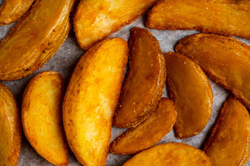 Rustic fried potato on paper background. Top view.