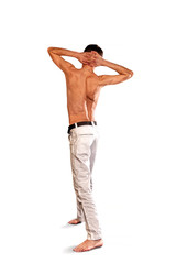 Fototapeta premium young guy stands with his back in white pants