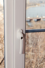 Handle with a lock on the window frame, a safety tool for children