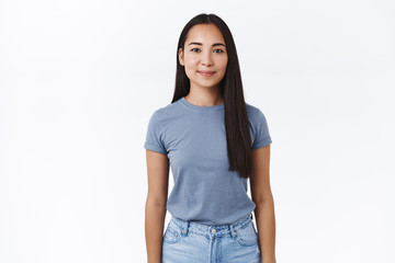 Obraz premium Portrait good-looking smiling young asian female student went abroad study and see world, grinning joyfully, standing in casual relaxed pose and express positivity, calm determined emotions