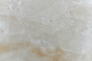Natural beige polished marble with natural inclusions. 
