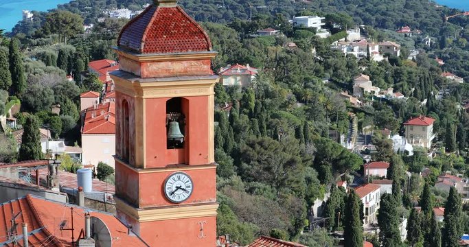 Aerial View Of A Medieval Church Bell Tower With Cap Martin In The Background, Old Village Of Roquebrune-Cap-Martin On The French Riviera In The Alpes-Maritimes In France - DCi 4K Resolution