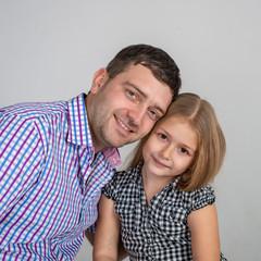 Obraz premium Shot of dad and little daughter against grey background