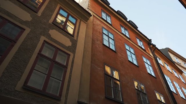 Apartment building streets in old northern european city. Scandinavian windows. Facades of colorful houses in the streets of Sweden. Traveling concept. Slow motion. Steadicam shot