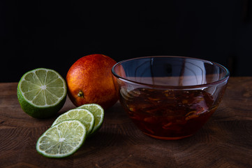  lime mandarin and jam on a dark background