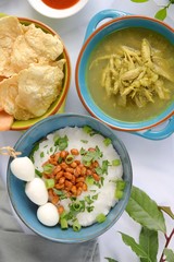 Bubur ayam, Indonesian rice porridge with shredded chicken, fried soybeans, quail eggs, scallions and crackers