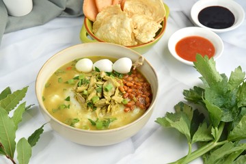 Bubur ayam, Indonesian rice porridge with shredded chicken, fried soybeans, quail eggs, scallions and crackers