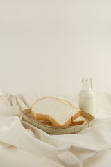 Obraz na płótnie Canvas Breakfast set fresh milk and bread on canvas background
