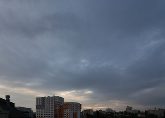 Dark dramatic clouds above on the city.