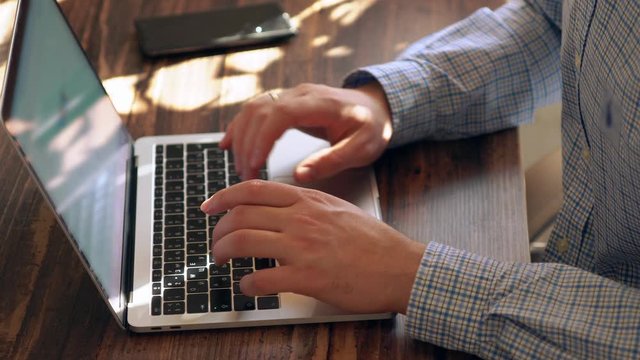 Man inputting data on a laptop computer