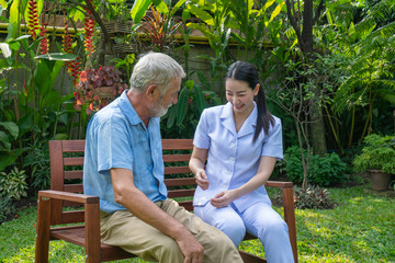 Young nurse take care senior man at home, Senior man happniess and smiling with nurse, Health care concept