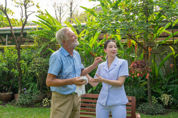 Young nurse take care senior man at home, Senior man happniess and smiling with nurse, Health care concept